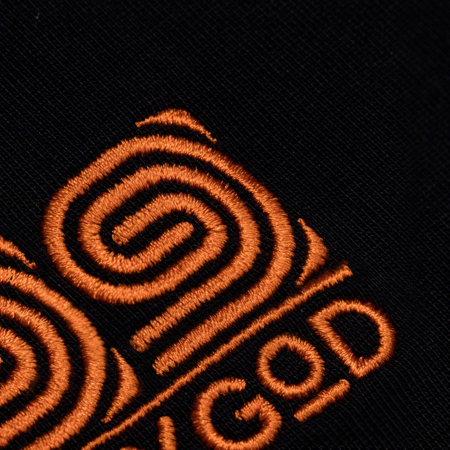 Close up of embroidered 99FOXGOD logo