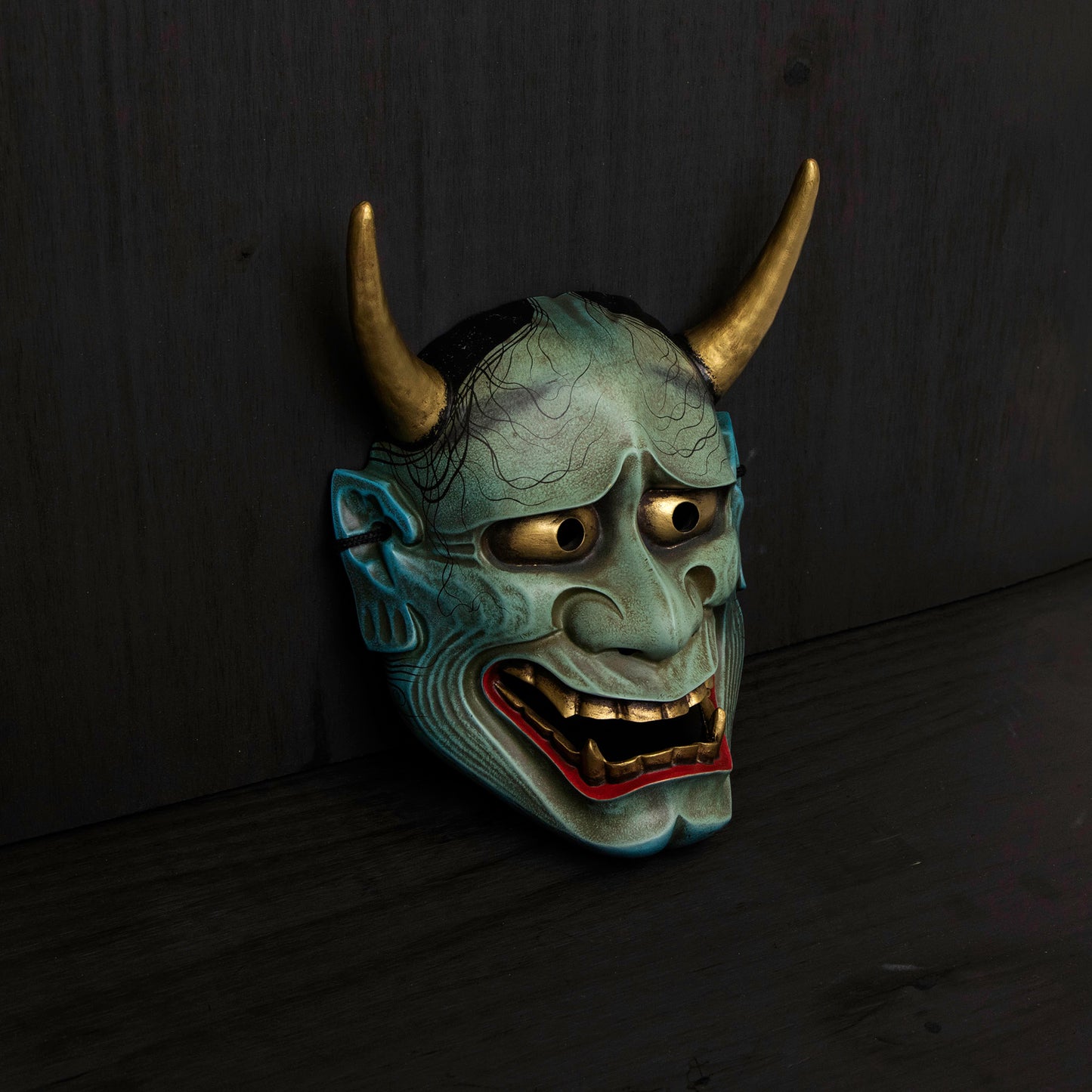 Peacock Blue Hannya Mask on the floor