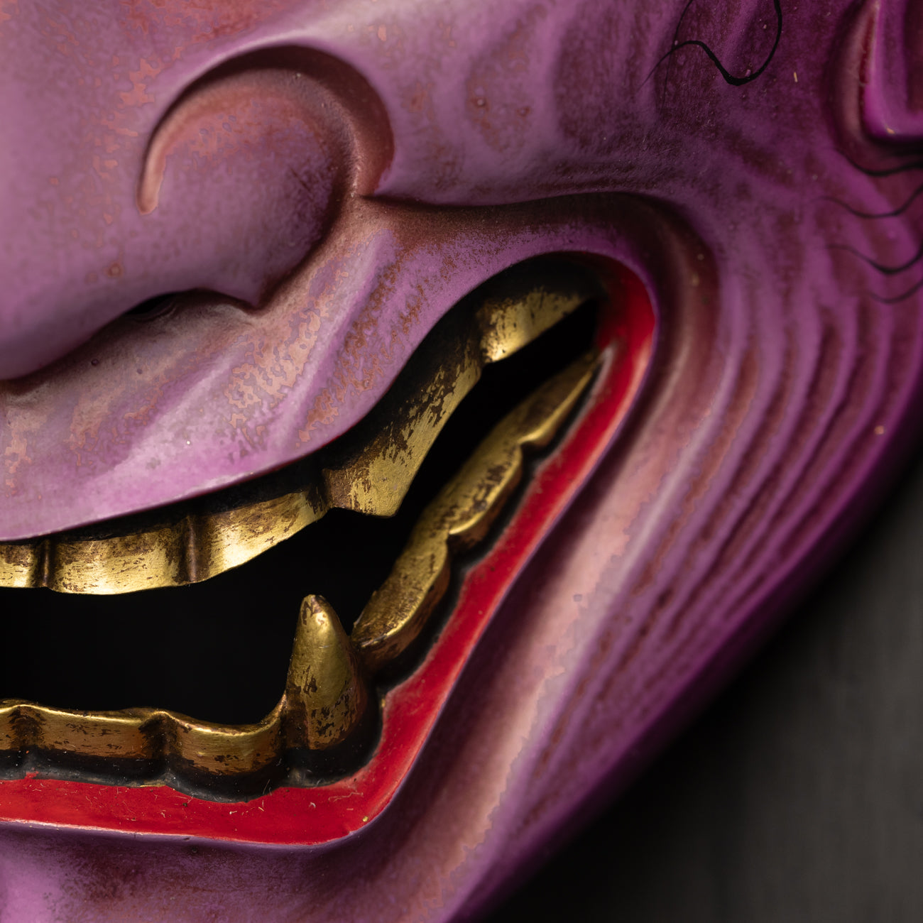 Purple Hannya Mask close up on gold fang