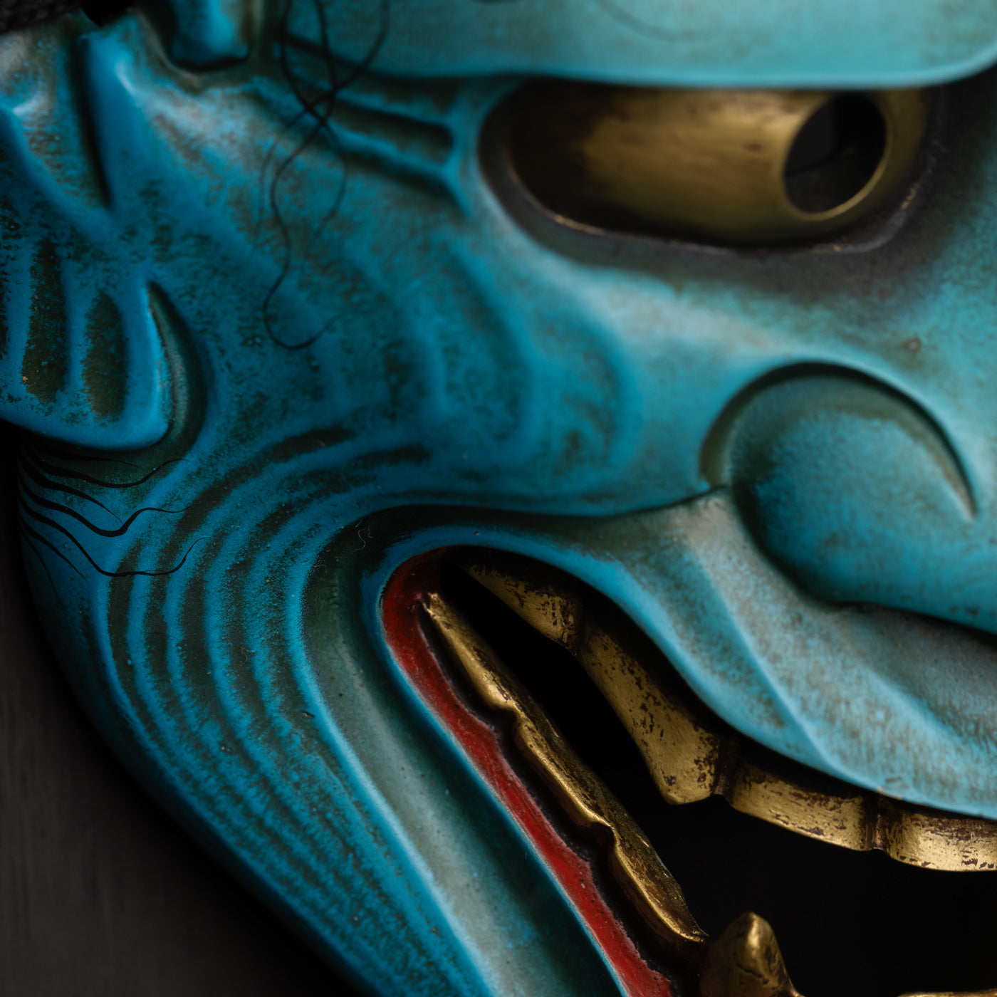 Real Blue Hannya Mask close up on gold teeth