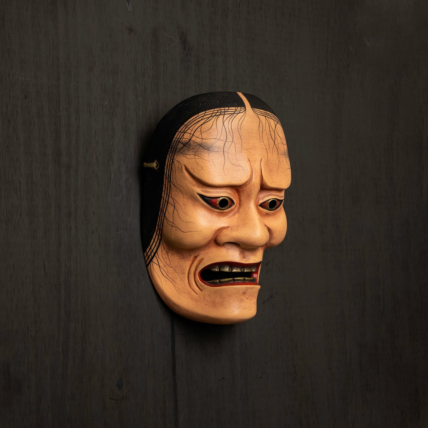 Hashihime Mask mounted on black wall