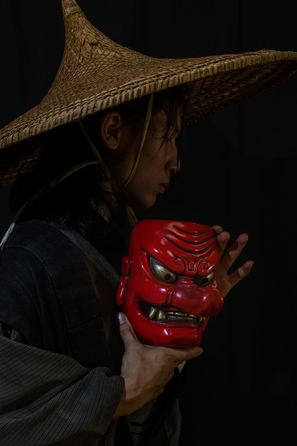 Model holding a Tengu Mask