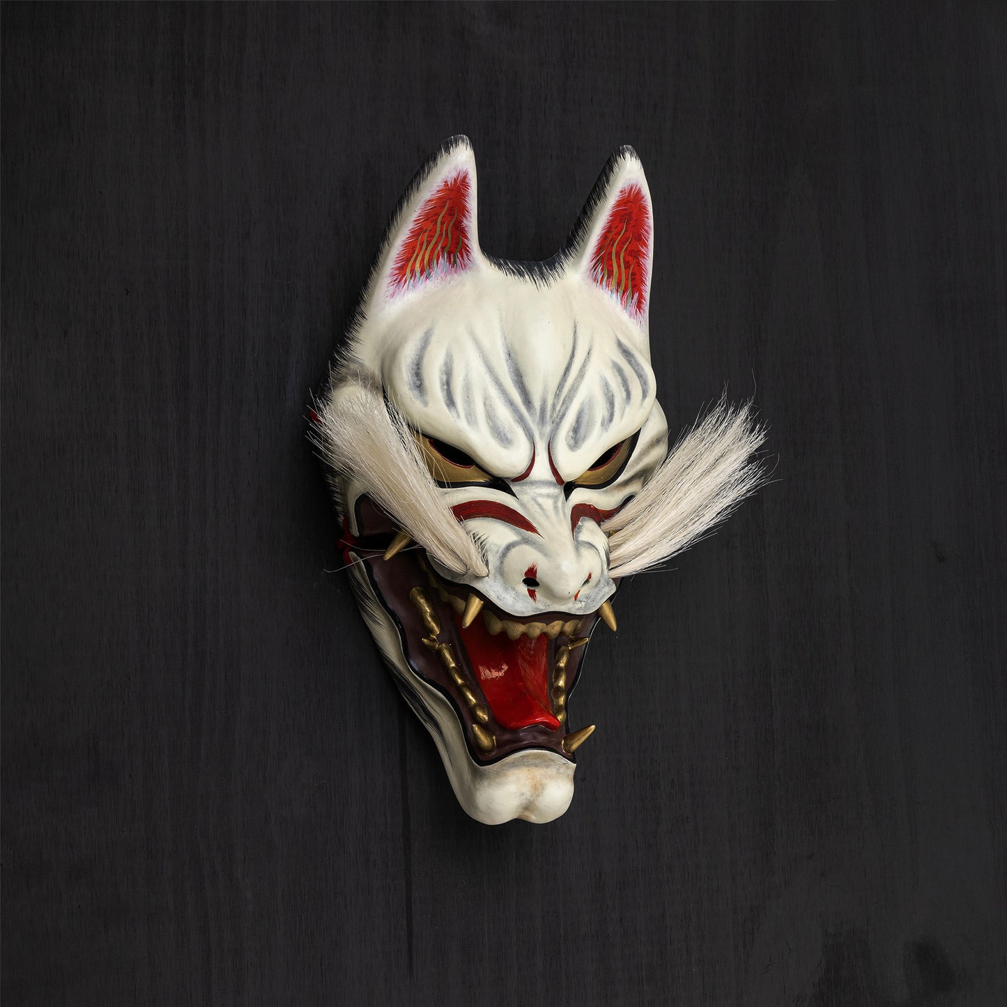 Kitsune Mask mounted on black wall